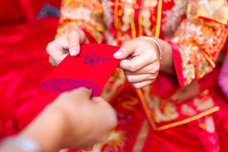 Chinese Bride Giving Red Pocket Lucky Money 692876656 12b59b9ea99c416da92d17b7c249bea8
