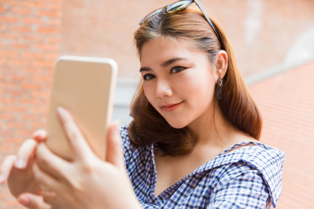 Attractive Happy Young Asian Woman Taking Her Selfie Outdoor_41451 88