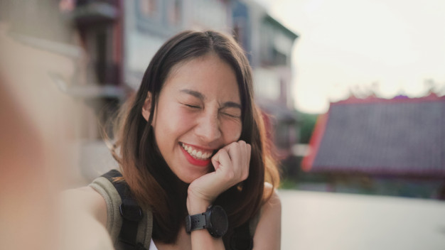 Cheerful Beautiful Young Asian Backpacker Blogger Woman Using Smartphone Taking Selfie_7861 1211