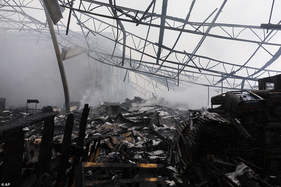29279554 8393533 Smoke_rises_from_a_burned_warehouse_Investigators_are_collecting A 41_1591399361892