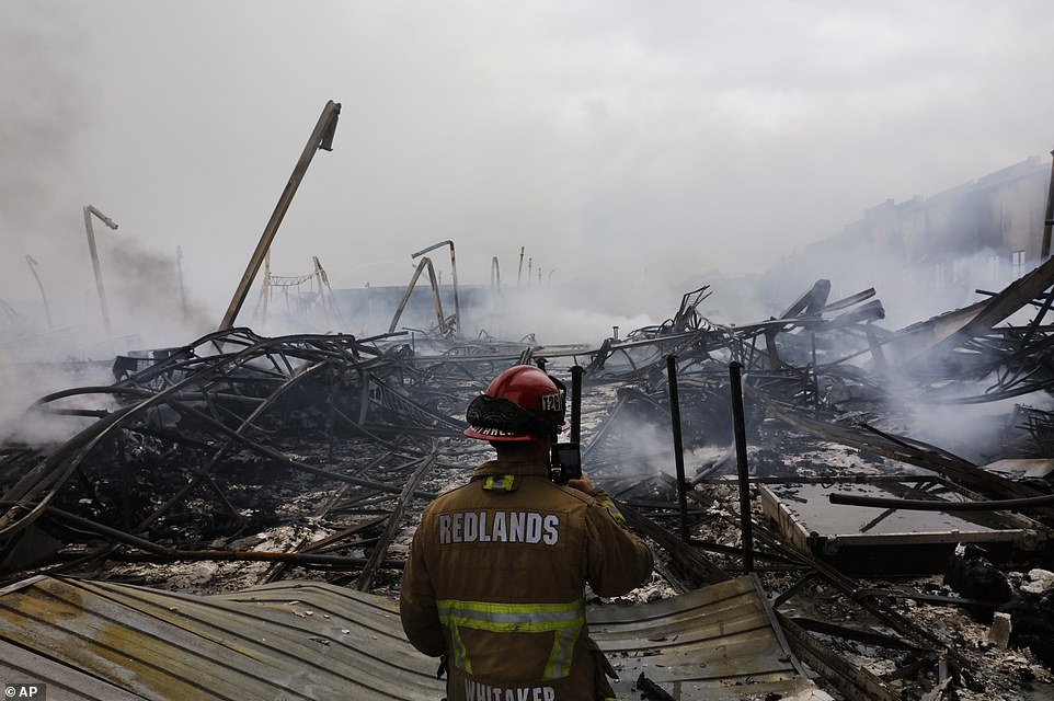 29279560 8393533 Redlands_Fire_Capt_Dustin_Whitaker_surveys_the_damage_at_the_war A 43_1591399361929