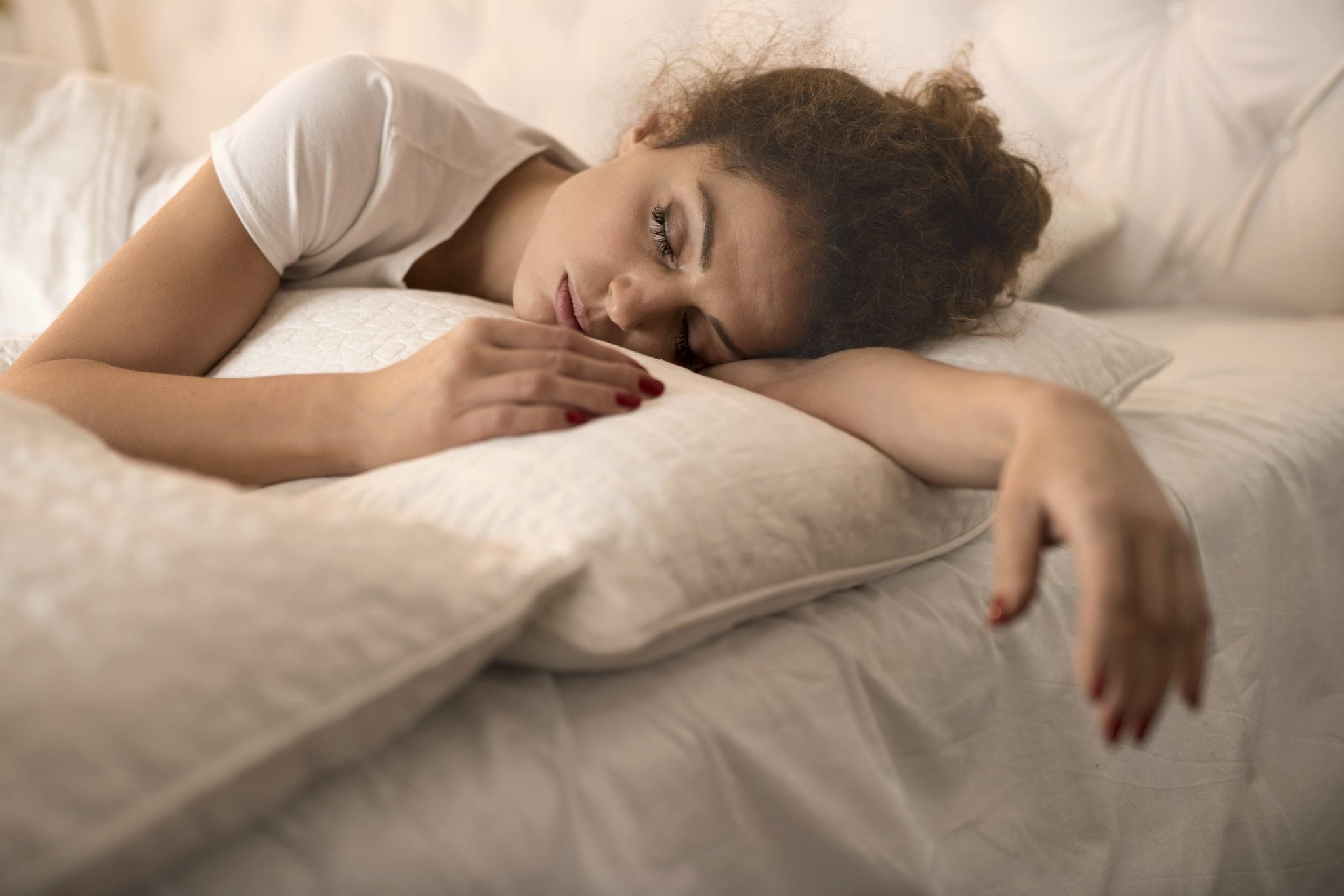 Tired Woman Sleeping In Bed