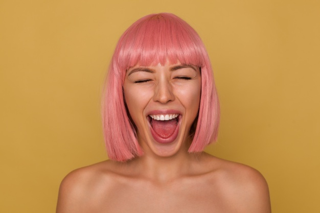 Good Looking Young Cheerful Attractive Woman With Pink Bob Hairstyle Keeping Her Mouth Wide Opened While Standing Mustard Background With Closed Eyes_295783 8879