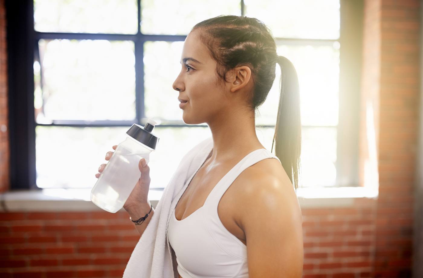 GettyImages When To Drink Water Intermittent Hydration Woman Waterbottle JeffBergen
