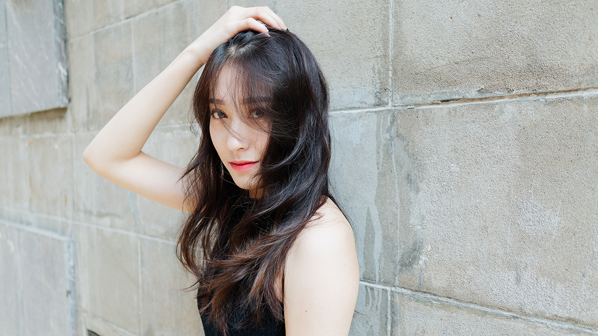 Graceful,Young,Woman,With,Long,Black,Hair,Gladly,Posing,With