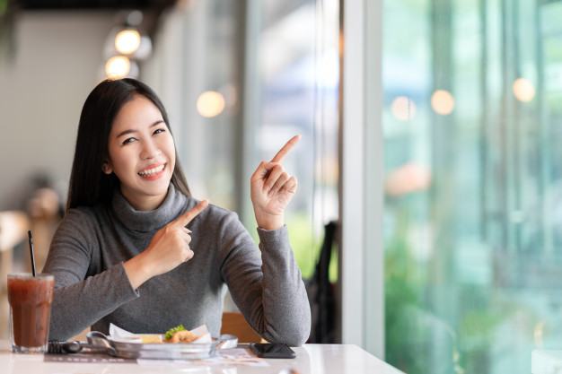 Young Attractive Asian Woman Pointing Up Side Showing Message_1439 94