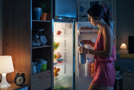 Woman Taking A Milk Bottle From The Fridge
