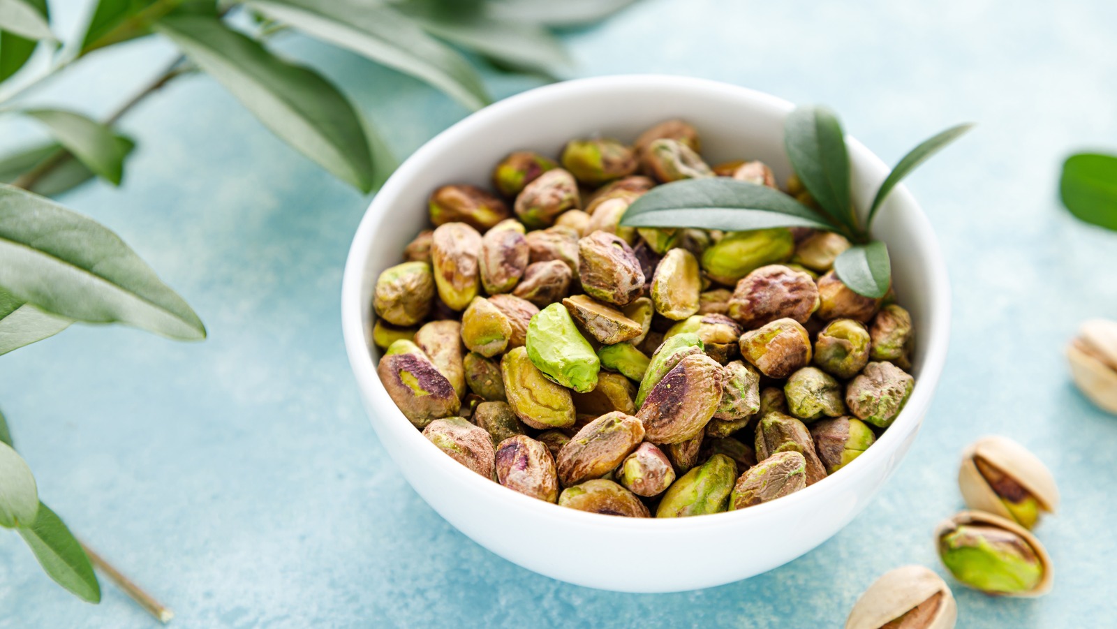 Pistachios.,Whole,Pistachios,With,Green,Leaves,And,Pistachio,Nut,Kernels.