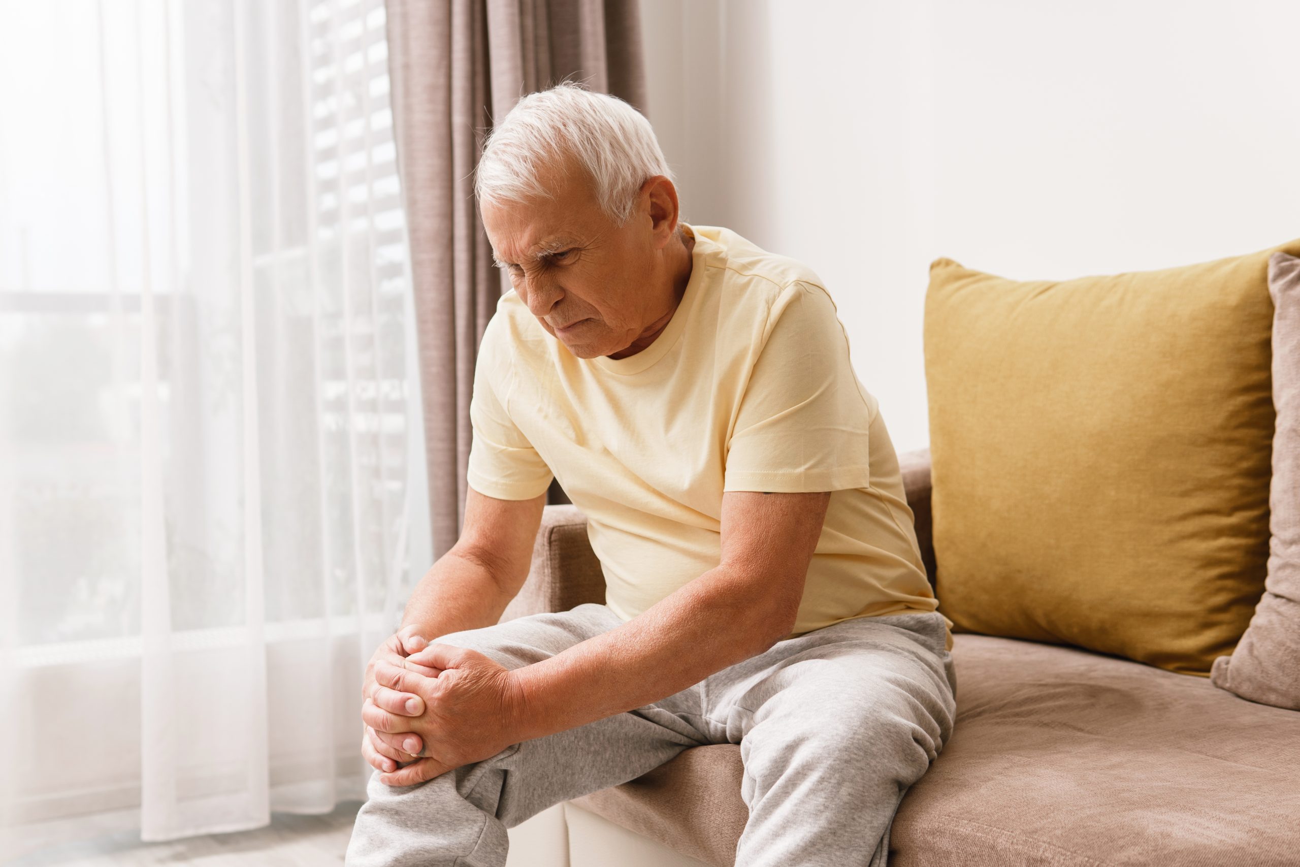 Senior Man Suffering From Pain His Knee Home Concept Problems With Joint Like Arthritis Scaled