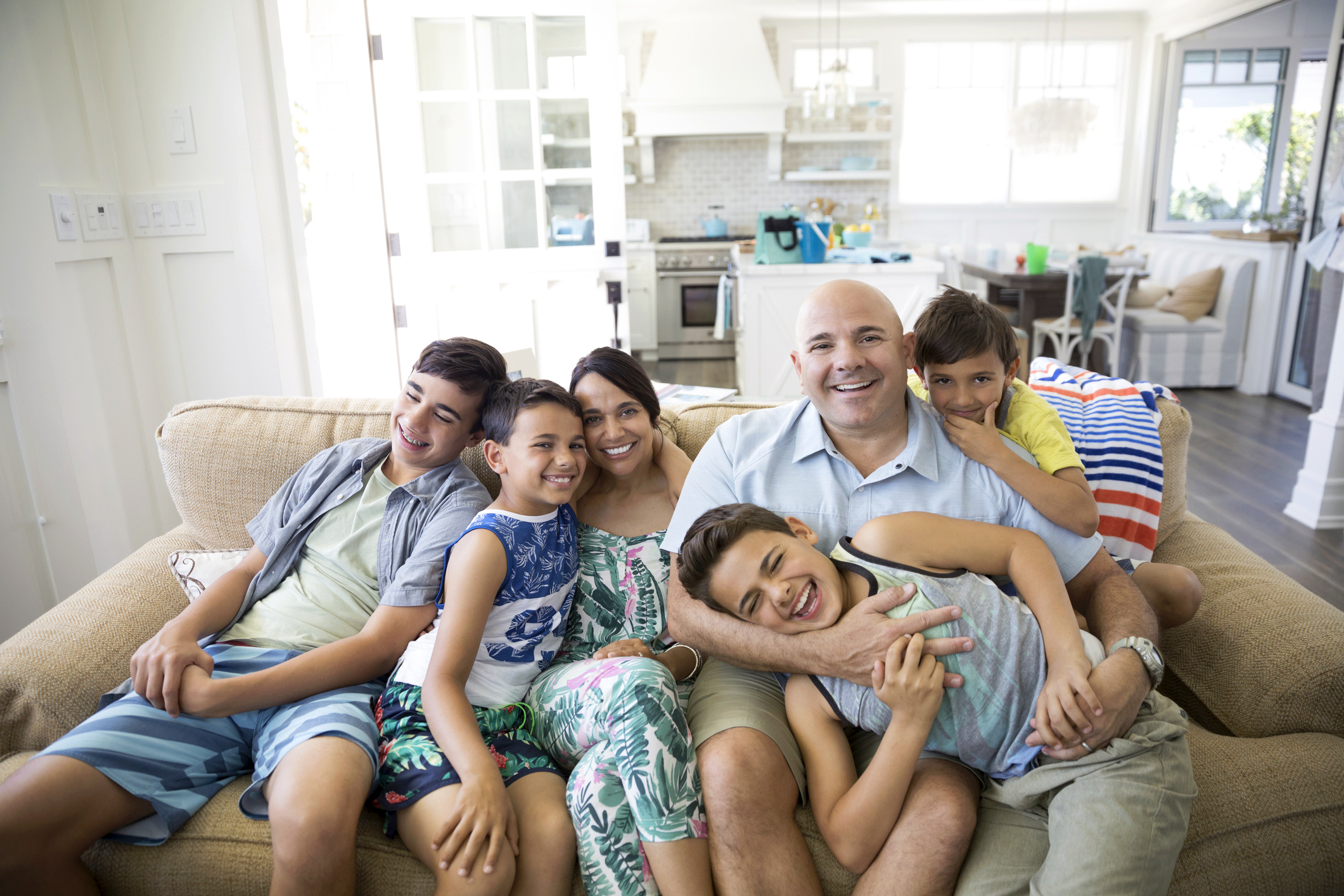 Portrait Smiling Family In Beach House Living Room