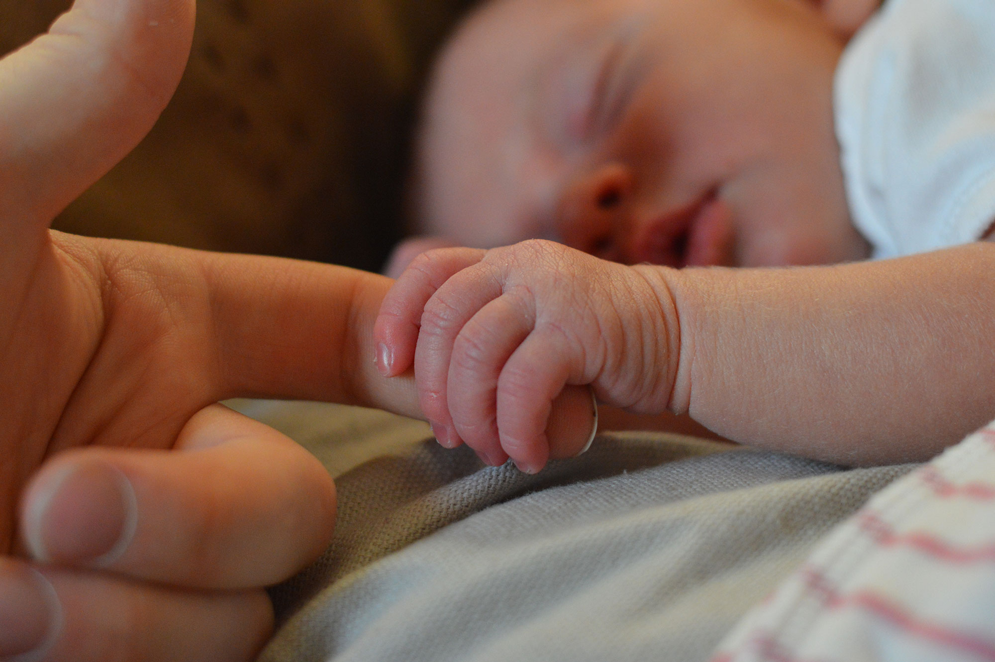 Baby Holding Human Finger 225744 1