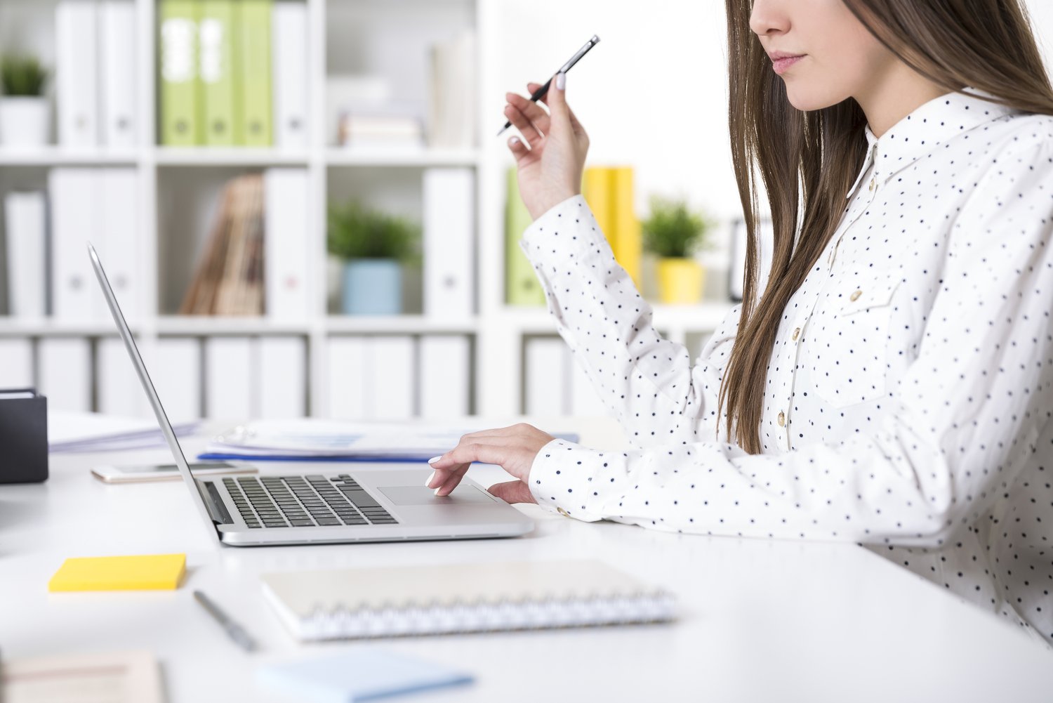 Close Up Of A Girl In A Polka Dot Shirt At Her Laptop In Office
