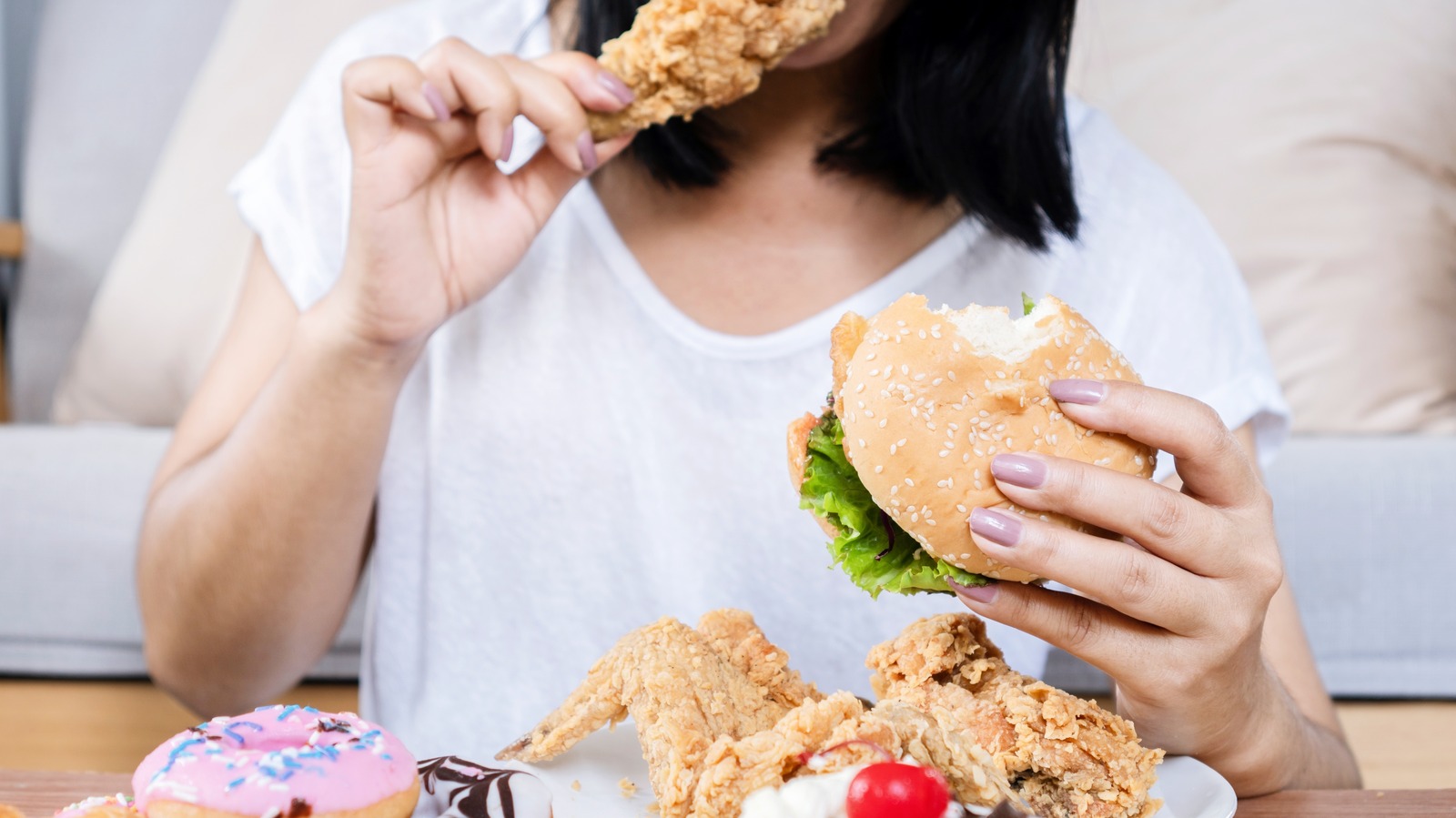 Binge,Eating,Disorder,Concept,With,Woman,Eating,Fast,Food,Burger,