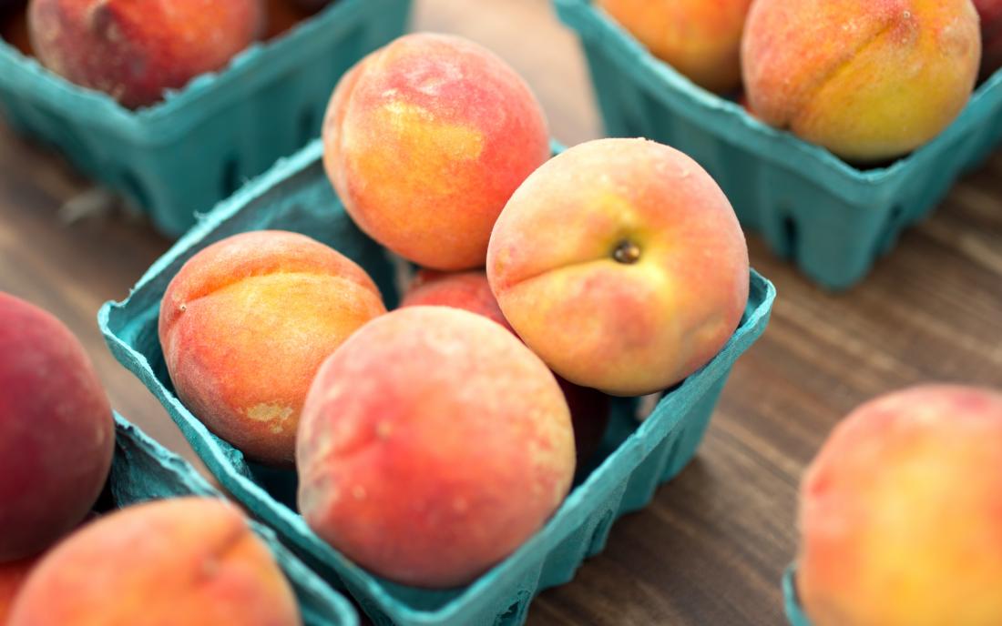 Peaches In Baskets On A Wooden Table