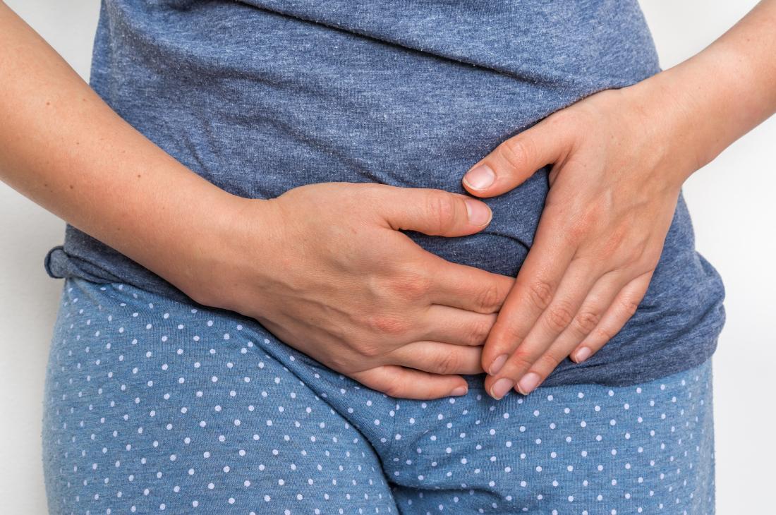 Woman Holding Left Side Of Pelvis In Pain