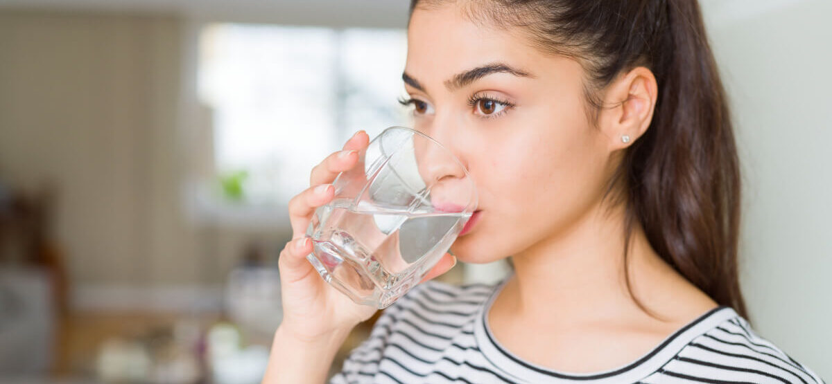 Beautiful Young Woman Drinking A Fresh Glass Of Water At Home E1660103042699