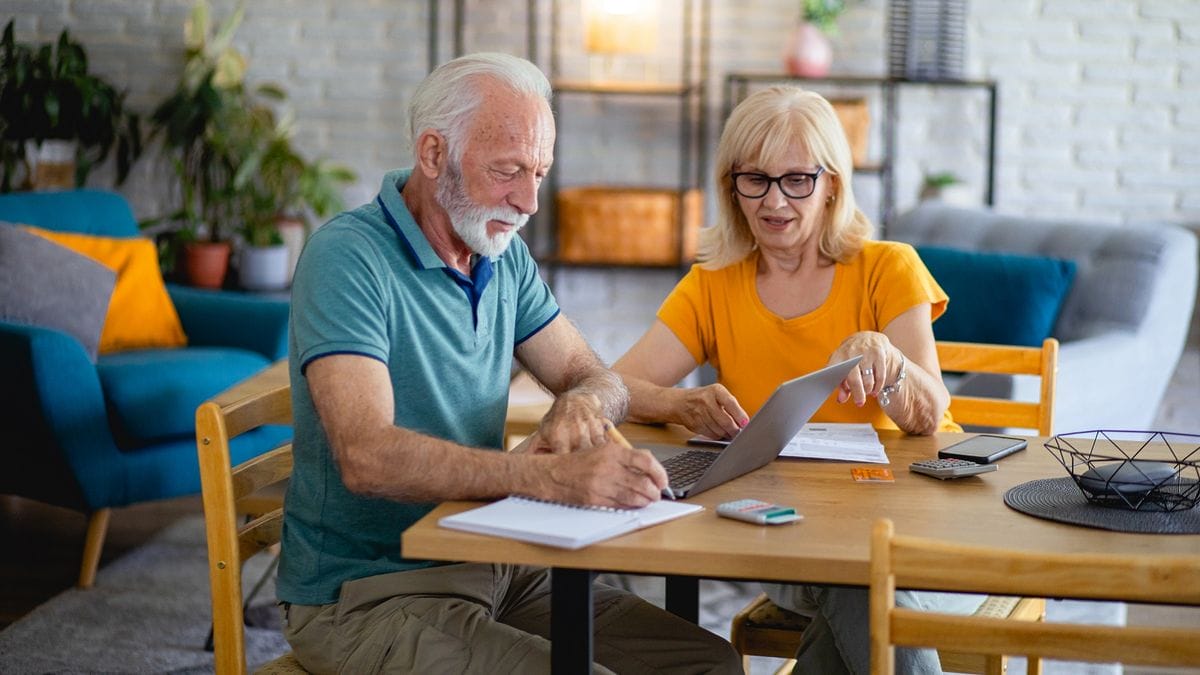Senior Couple Using Laptop While Planning Their Home Budget